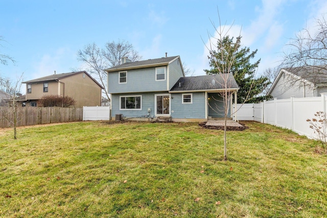 rear view of house with a lawn