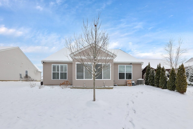 snow covered property featuring central AC unit