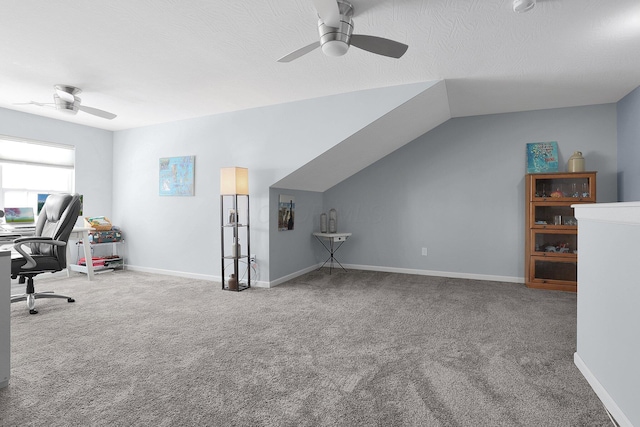 unfurnished office featuring lofted ceiling, a textured ceiling, ceiling fan, and carpet