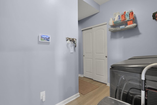 laundry room featuring washer and dryer and light hardwood / wood-style flooring