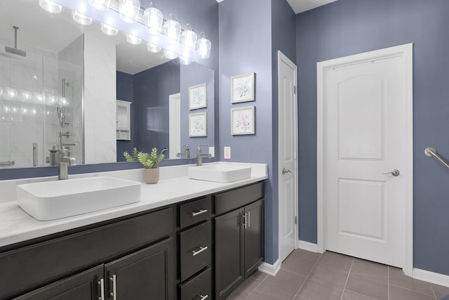 bathroom featuring tile patterned flooring, vanity, and a shower with shower door