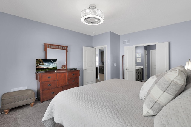 bedroom featuring carpet floors and connected bathroom