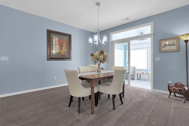 dining space featuring carpet floors and an inviting chandelier