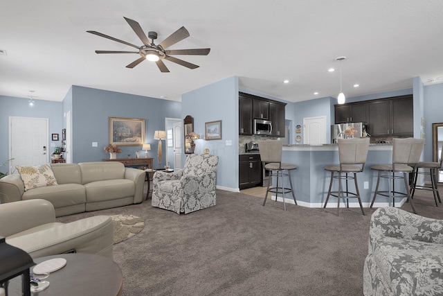 carpeted living room with ceiling fan