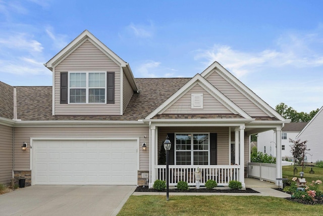 craftsman-style home featuring a porch, a garage, and a front yard