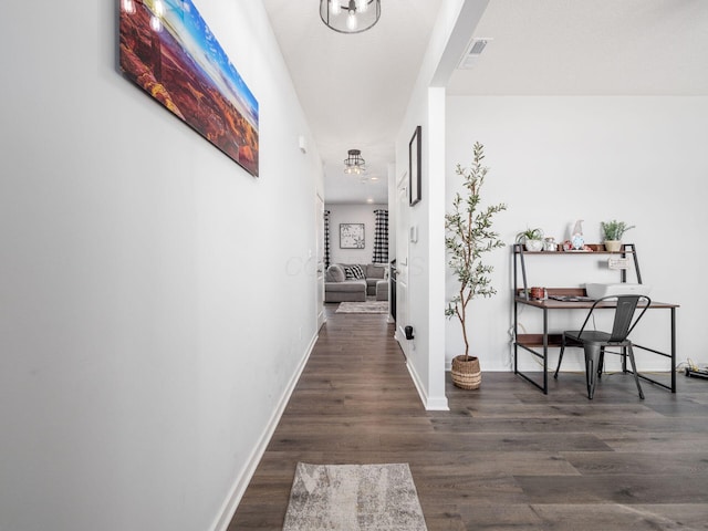 corridor with dark hardwood / wood-style floors