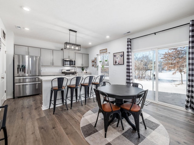 dining space with dark wood-type flooring