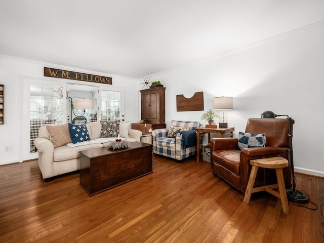 living room with dark wood-type flooring and ornamental molding