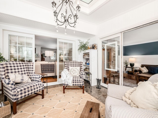 living room featuring ornamental molding and a notable chandelier