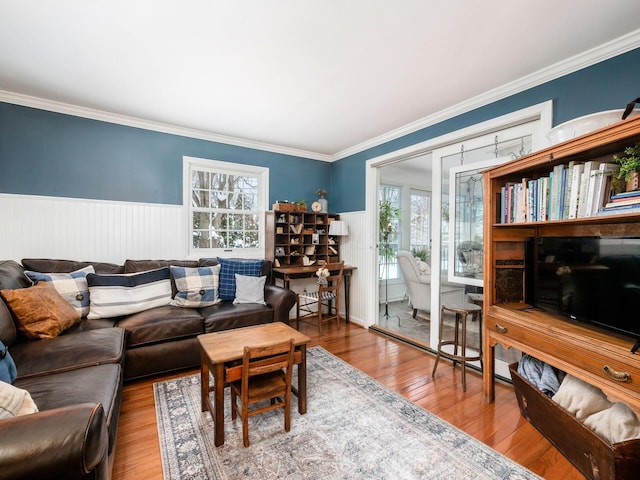 living room with hardwood / wood-style flooring and ornamental molding