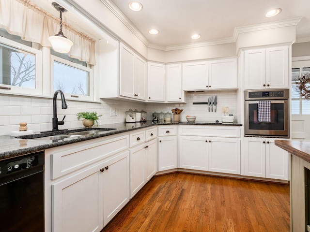 kitchen with dishwasher, white cabinetry, oven, and sink