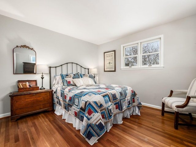 bedroom with dark wood-type flooring