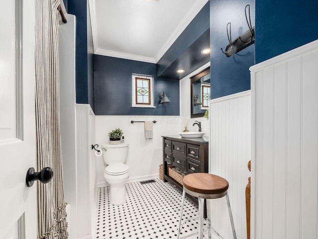 bathroom featuring vanity, toilet, and crown molding