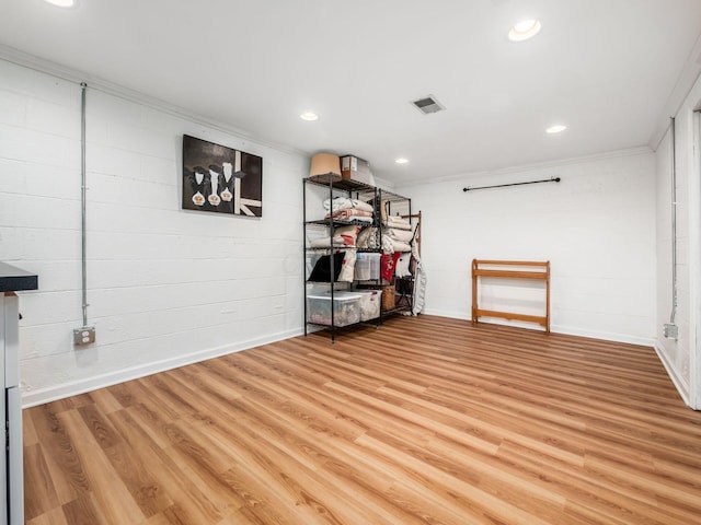 basement with crown molding and hardwood / wood-style floors