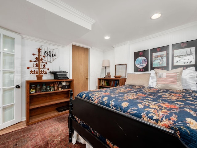 bedroom with hardwood / wood-style floors and ornamental molding