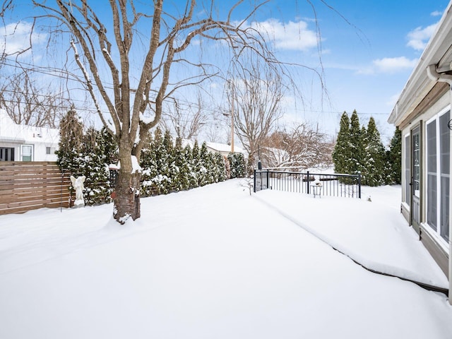 snowy yard featuring a wooden deck