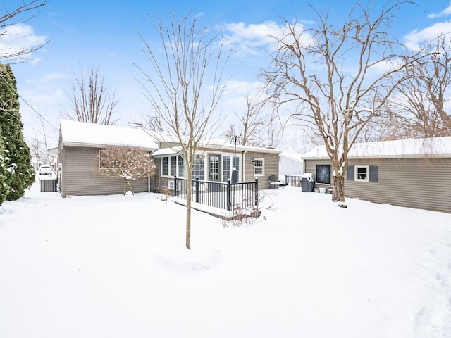 view of snow covered rear of property