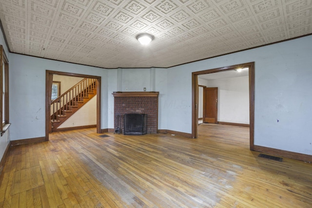 unfurnished living room featuring hardwood / wood-style flooring and a fireplace