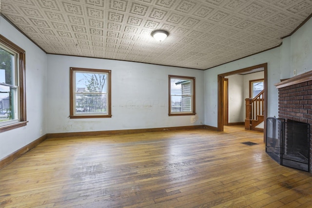 unfurnished living room with a fireplace and light hardwood / wood-style floors