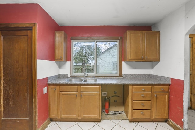 kitchen with light tile patterned floors and sink