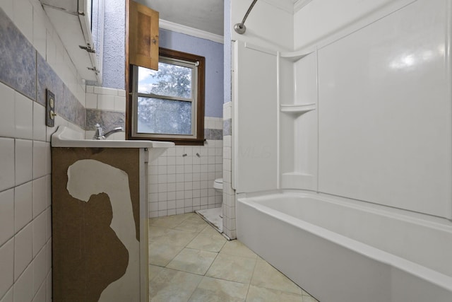 bathroom featuring vanity,  shower combination, tile patterned floors, ornamental molding, and tile walls