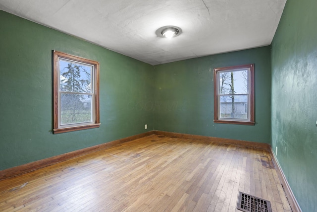 spare room featuring light wood-type flooring