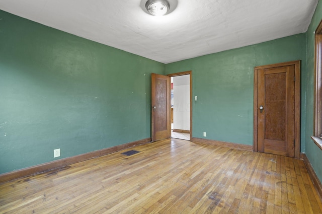 unfurnished bedroom featuring light wood-type flooring