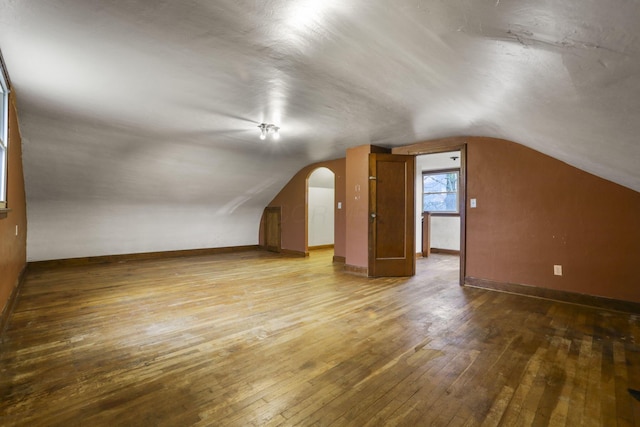 bonus room with hardwood / wood-style flooring and lofted ceiling