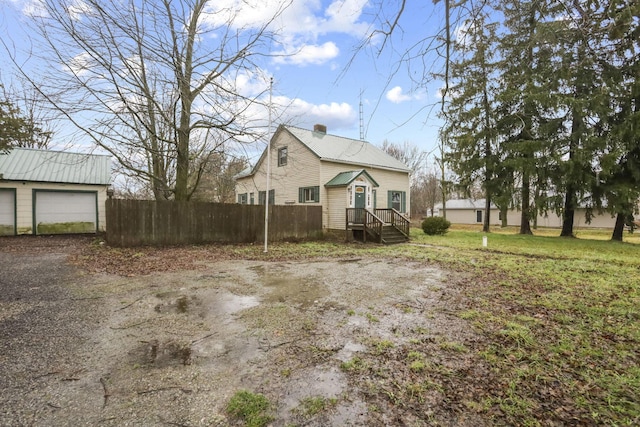 view of home's exterior featuring an outdoor structure and a garage