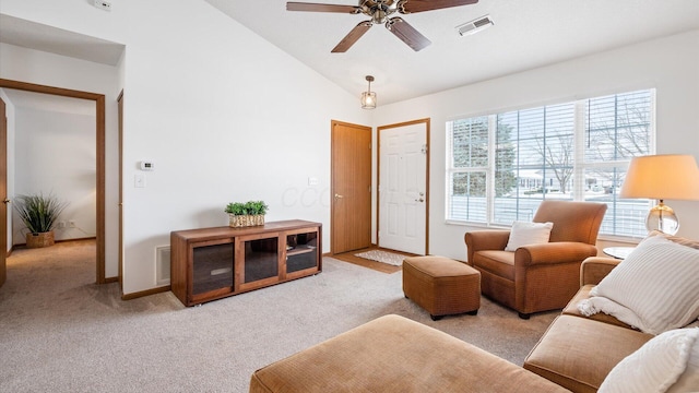 living room with ceiling fan, lofted ceiling, and light carpet