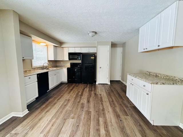 kitchen featuring a sink, black appliances, dark wood-style flooring, and white cabinetry