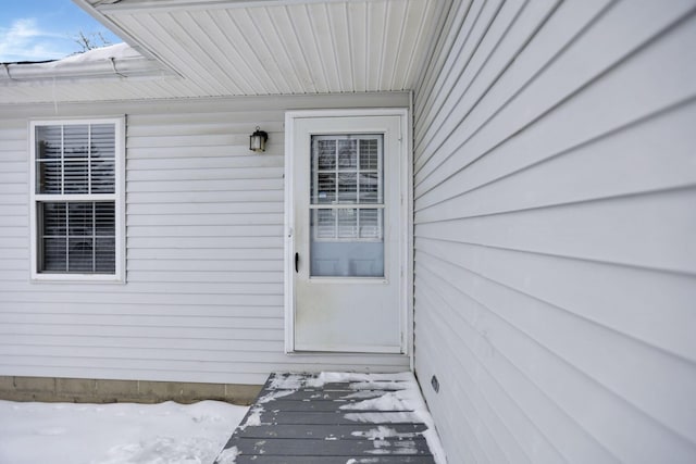 view of snow covered property entrance