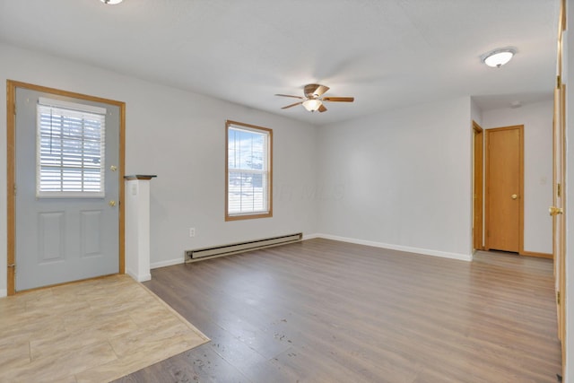 entryway featuring ceiling fan, a baseboard radiator, and light wood-type flooring