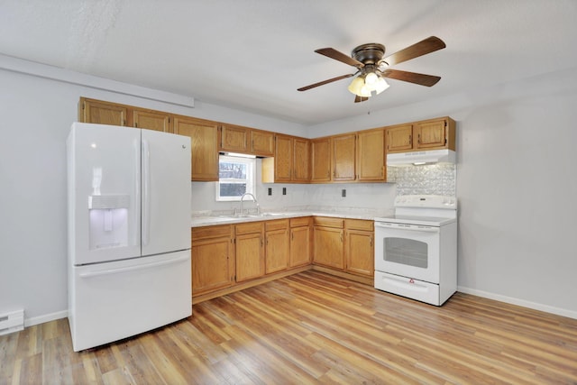 kitchen featuring light hardwood / wood-style floors, white appliances, sink, and tasteful backsplash