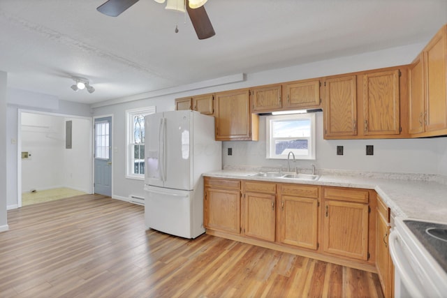 kitchen featuring ceiling fan, sink, light hardwood / wood-style floors, and white fridge with ice dispenser