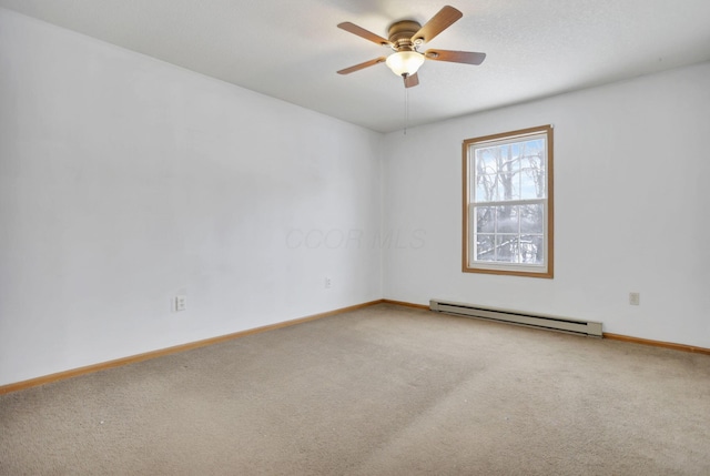 empty room with ceiling fan, carpet floors, and a baseboard heating unit