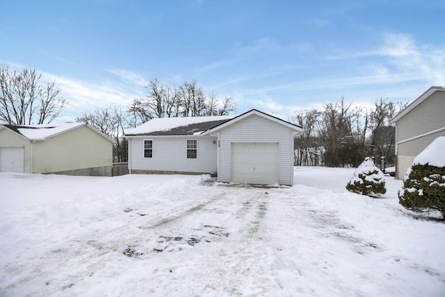 snow covered property featuring a garage