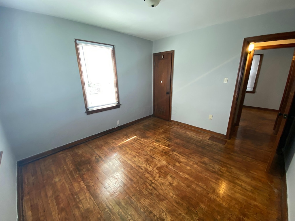 spare room featuring dark hardwood / wood-style floors