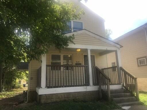 rear view of property with a porch