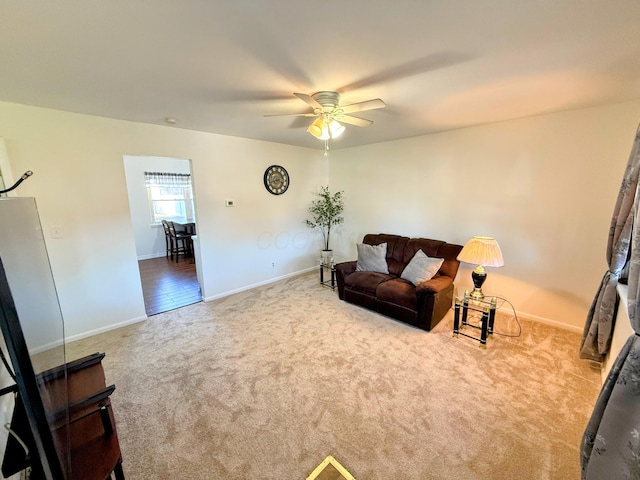 living room with light colored carpet and ceiling fan