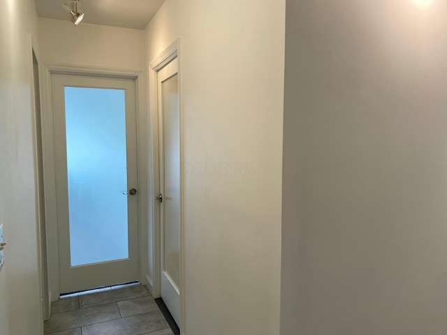 doorway to outside featuring tile patterned floors