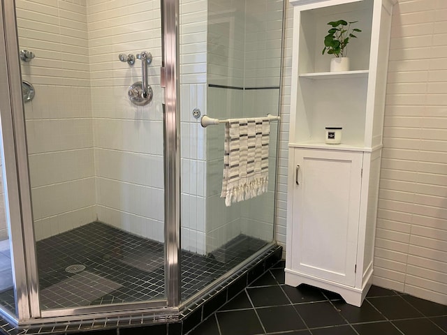 bathroom featuring walk in shower and tile patterned flooring