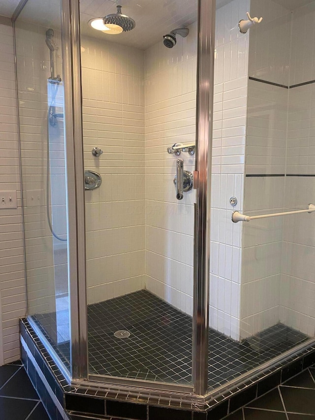 bathroom with tile patterned floors and a shower with shower door