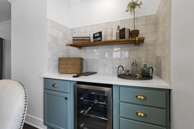 bar featuring crown molding, blue cabinets, backsplash, and wine cooler