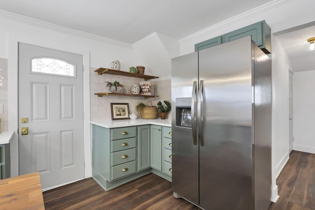 kitchen with green cabinets, decorative backsplash, stainless steel fridge, ornamental molding, and dark hardwood / wood-style flooring