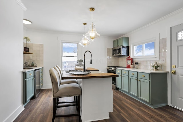 kitchen with wooden counters, decorative backsplash, decorative light fixtures, a healthy amount of sunlight, and stainless steel appliances