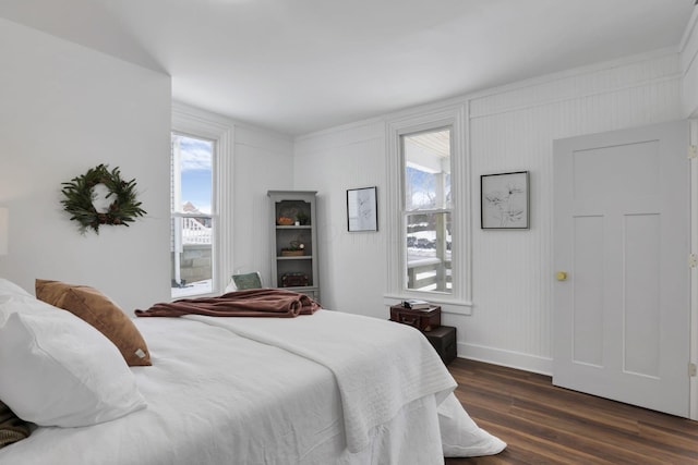 bedroom with dark hardwood / wood-style floors