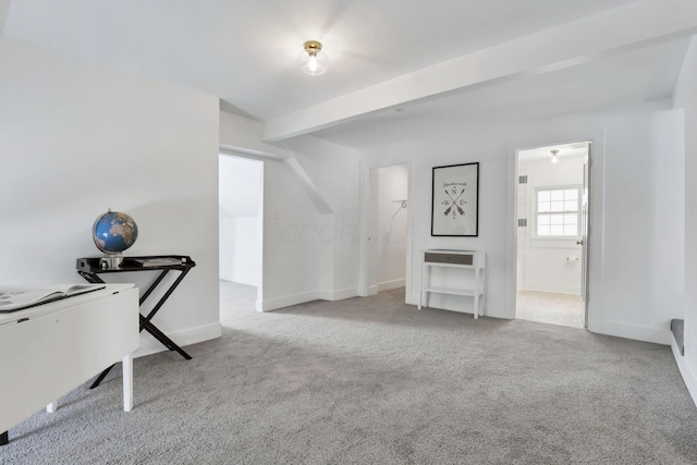 misc room with beam ceiling and light colored carpet