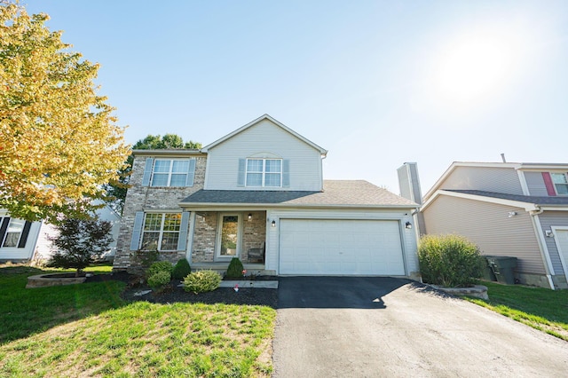 view of front property with a garage and a front lawn