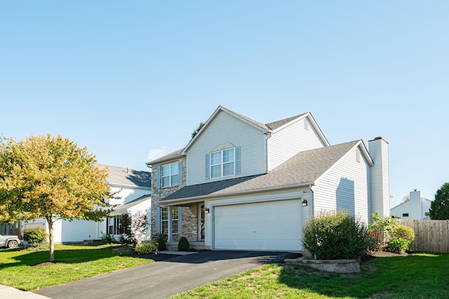 view of front of house featuring a garage and a front yard